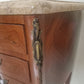 Corner of  Louis XV style wooden nightstand with marble top on a plain background