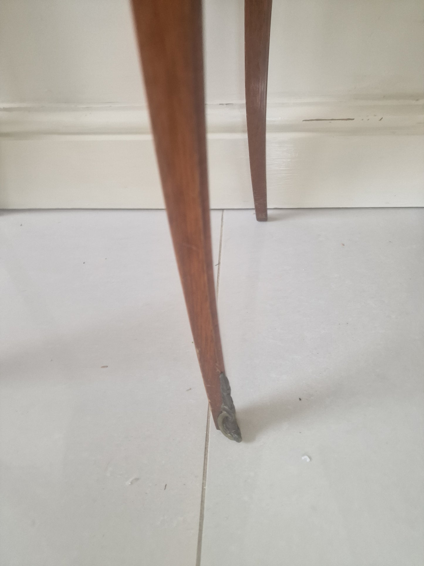Legs of  Louis XV style wooden nightstand on a plain background