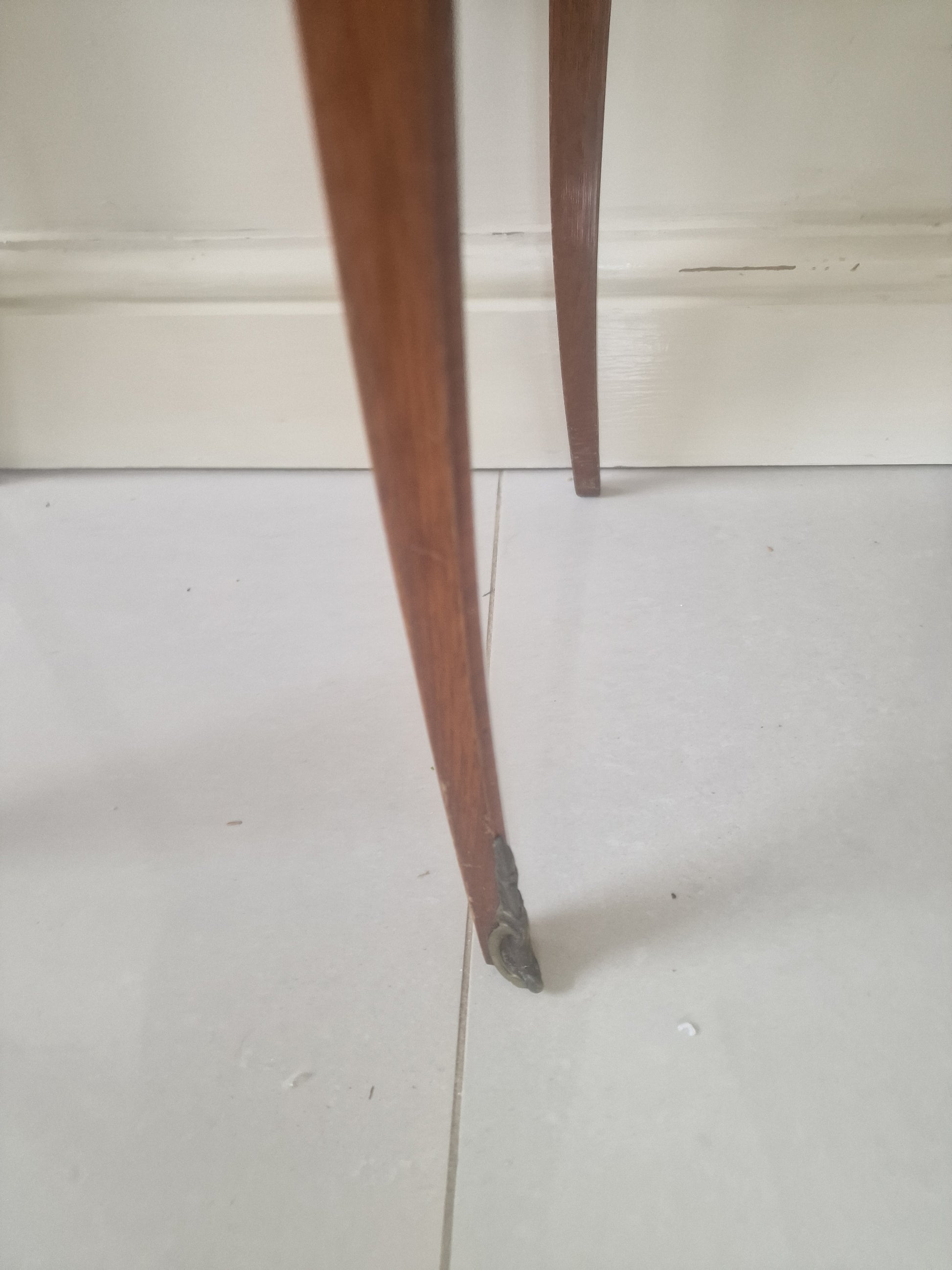 Legs of  Louis XV style wooden nightstand on a plain background