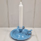 Vintage blue enamel French chamber candlestick on white table