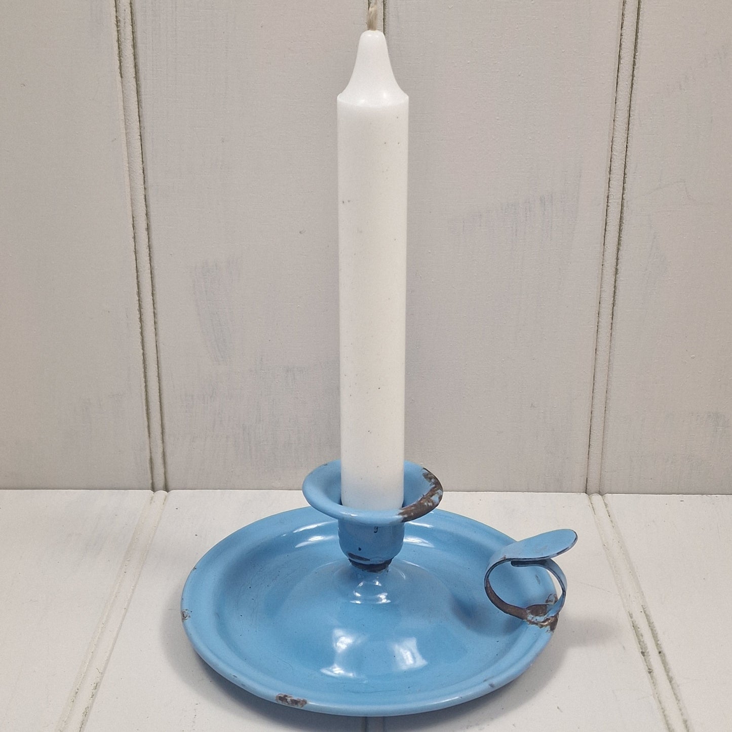Vintage blue enamel French chamber candlestick on white table