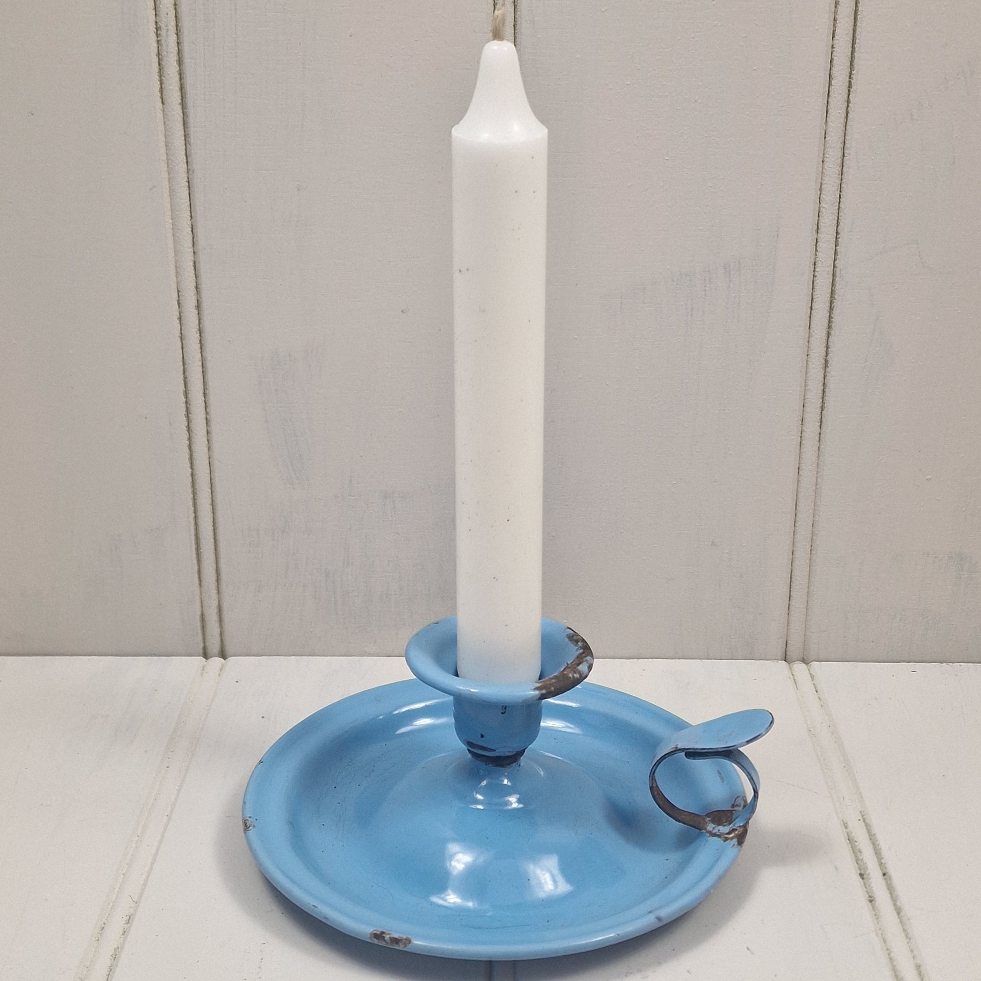 Vintage blue enamel French chamber candlestick on white table