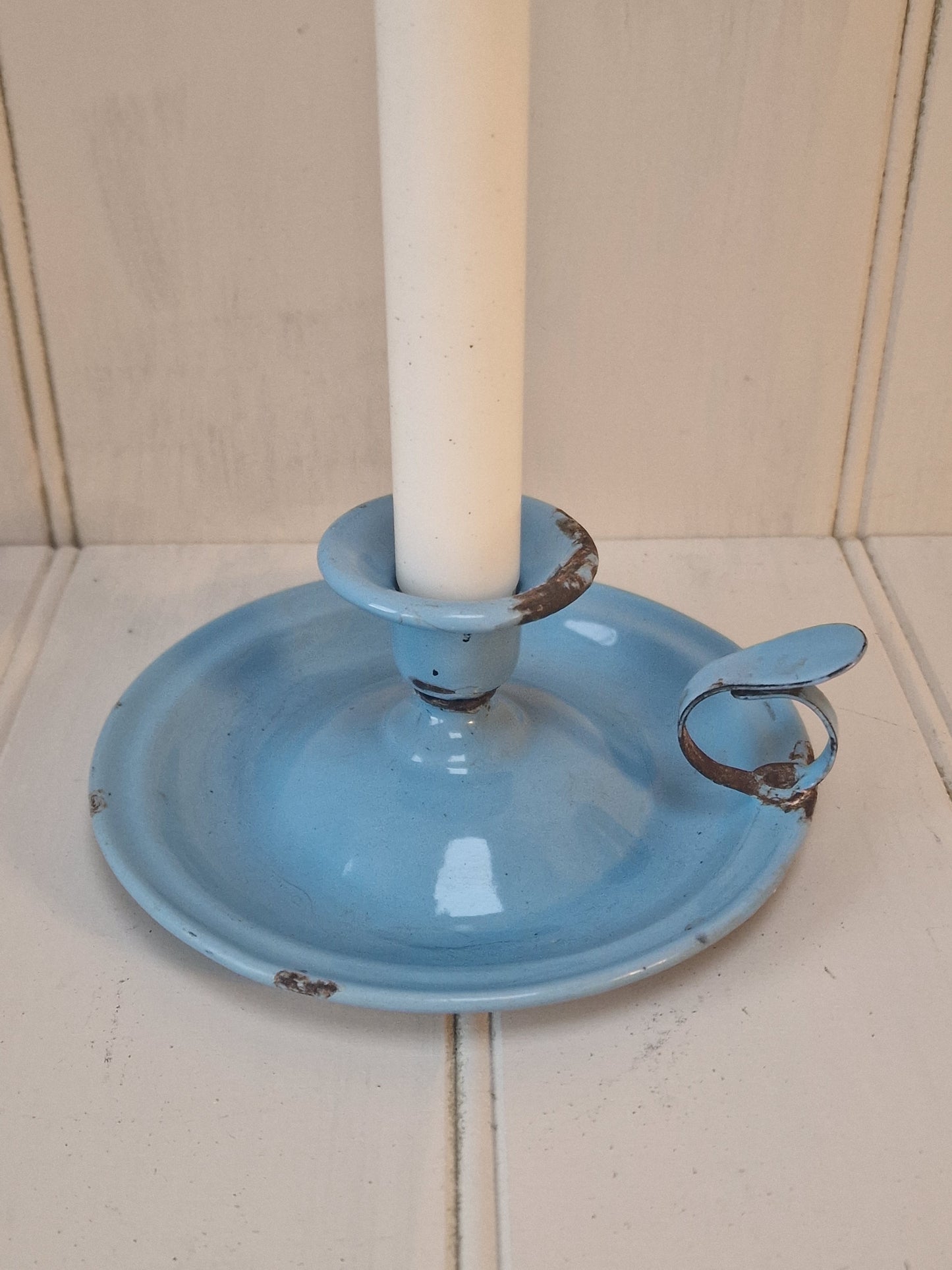 Vintage blue enamel French chamber candlestick on white table