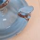 Vintage blue enamel French chamber candlestick on white table