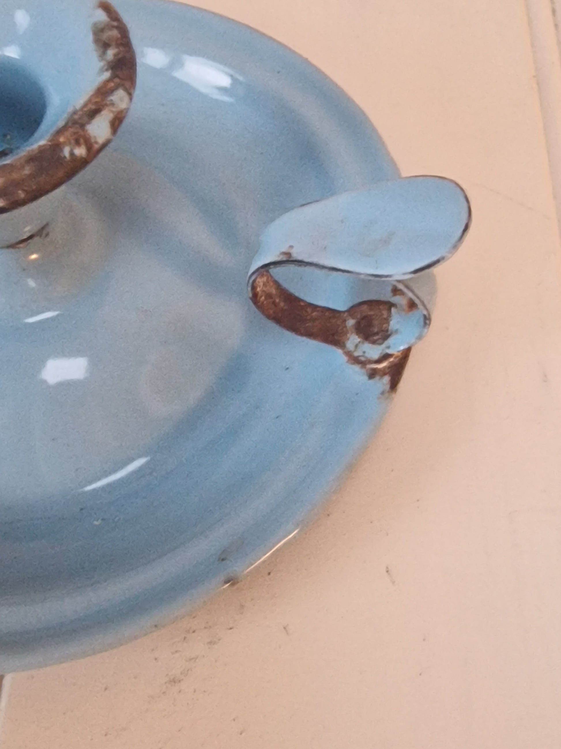 Vintage blue enamel French chamber candlestick on white table