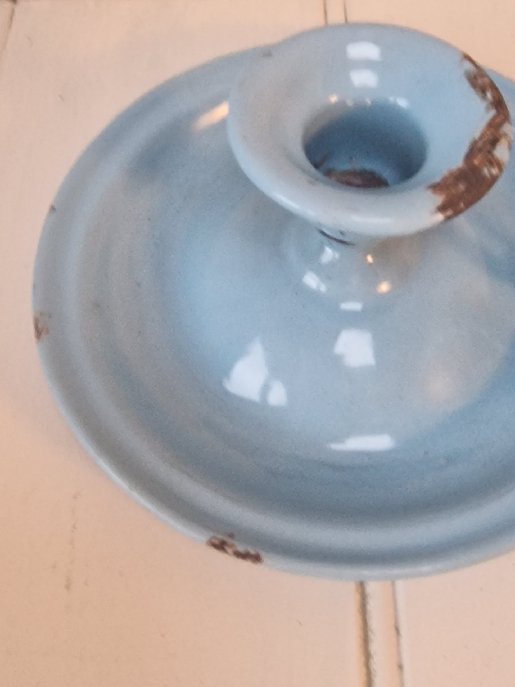 Vintage blue enamel French chamber candlestick on white table