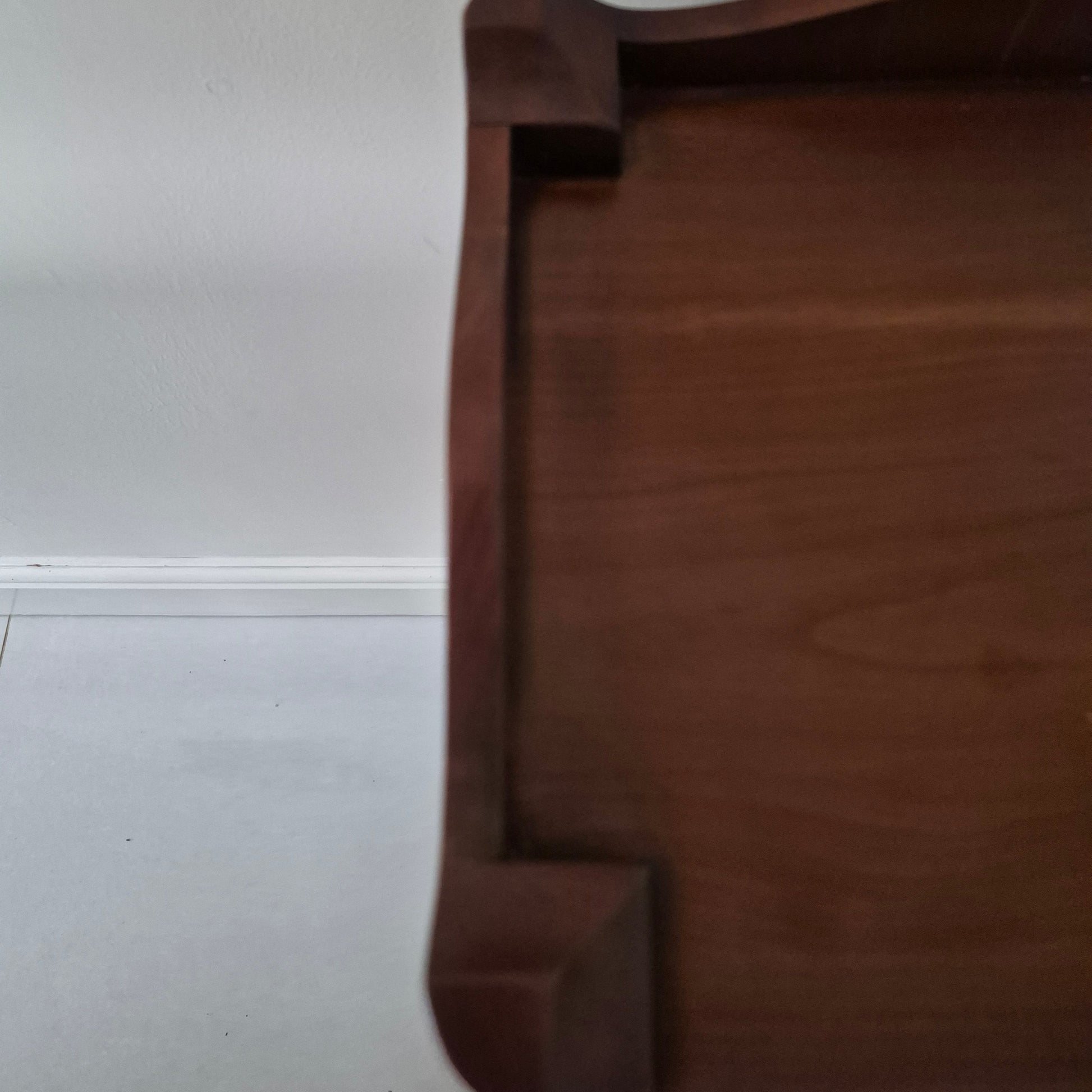 Edge of dark wood bedside table