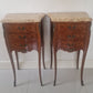 Pair of French Louis XV style wooden nightstands with marble tops on a plain background